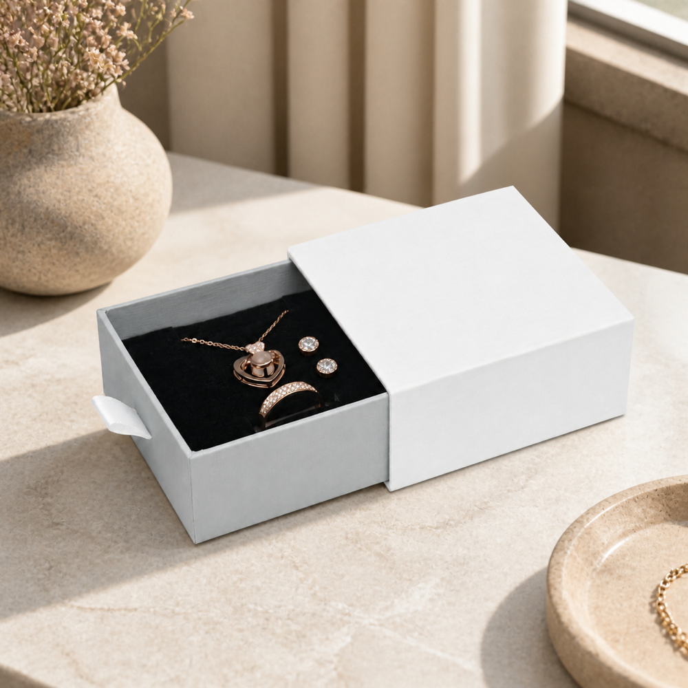 Silver drawer jewelry box with rings, earrings and pendant in an elegant jewelry boutique scene.