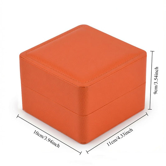 Orange wristwatch gift packaging case featuring a hinged lid and clean white interior.