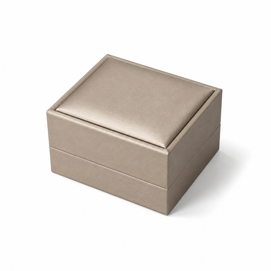 Closed champagne PU double ring box on a white background