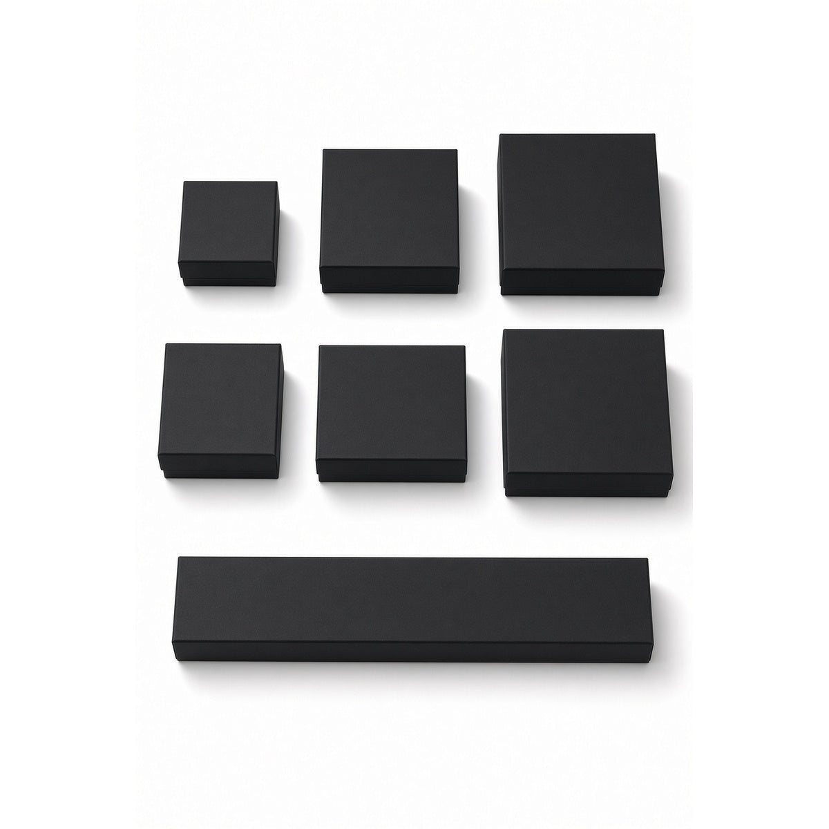 Seven black cardstock custom magnetic jewelry box sizes on a pure white background