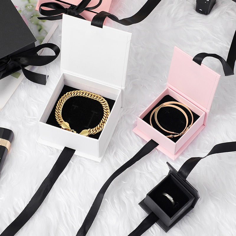 White and pink ribbon-closure flip-top jewelry box presentation view