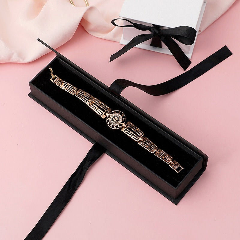 Black ribbon-closure flip-top jewelry box for bracelet presentation