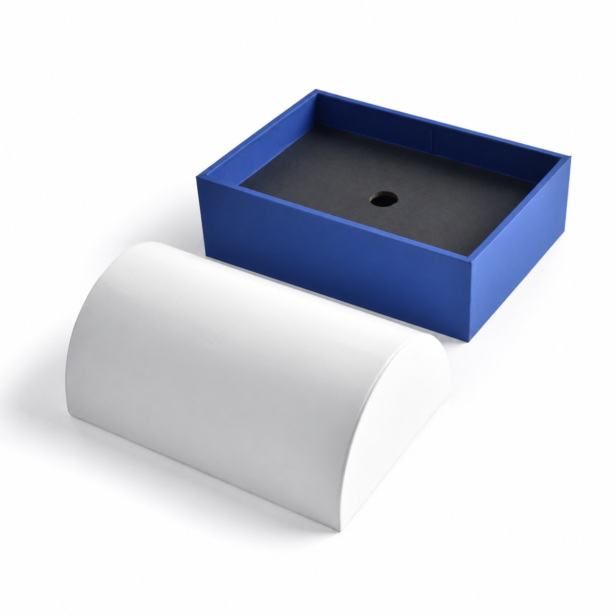 White arc-shaped bracelet presentation insert inside a blue jewelry display base