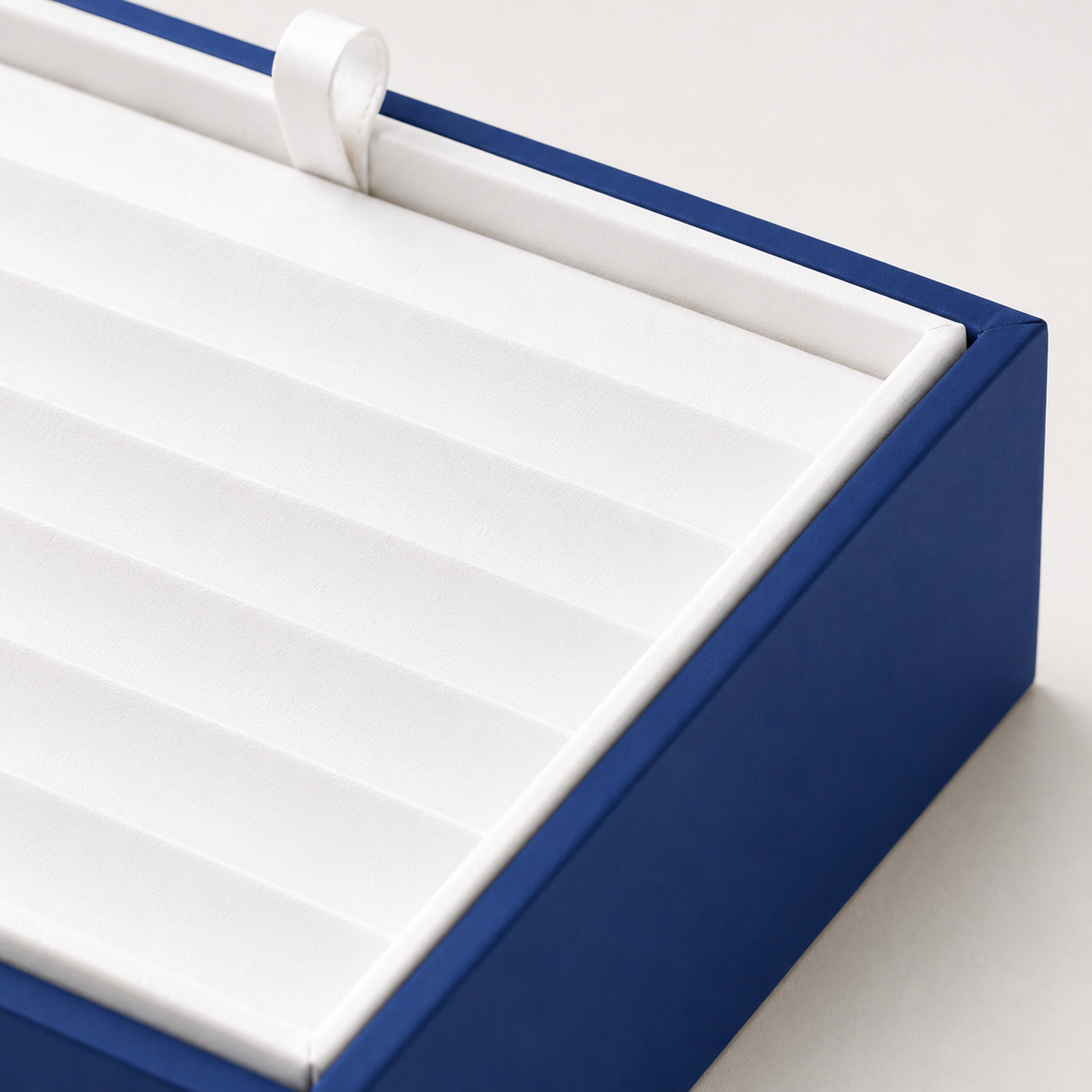 Blue and white jewelry tray for organizing bracelets, chains, and bangles