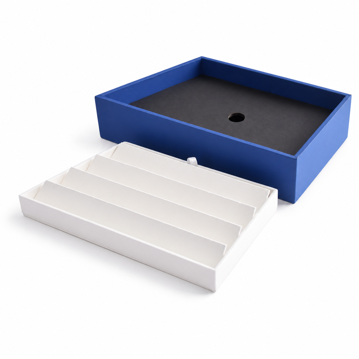 Four-row white slotted earring organizer tray inside a blue jewelry display base