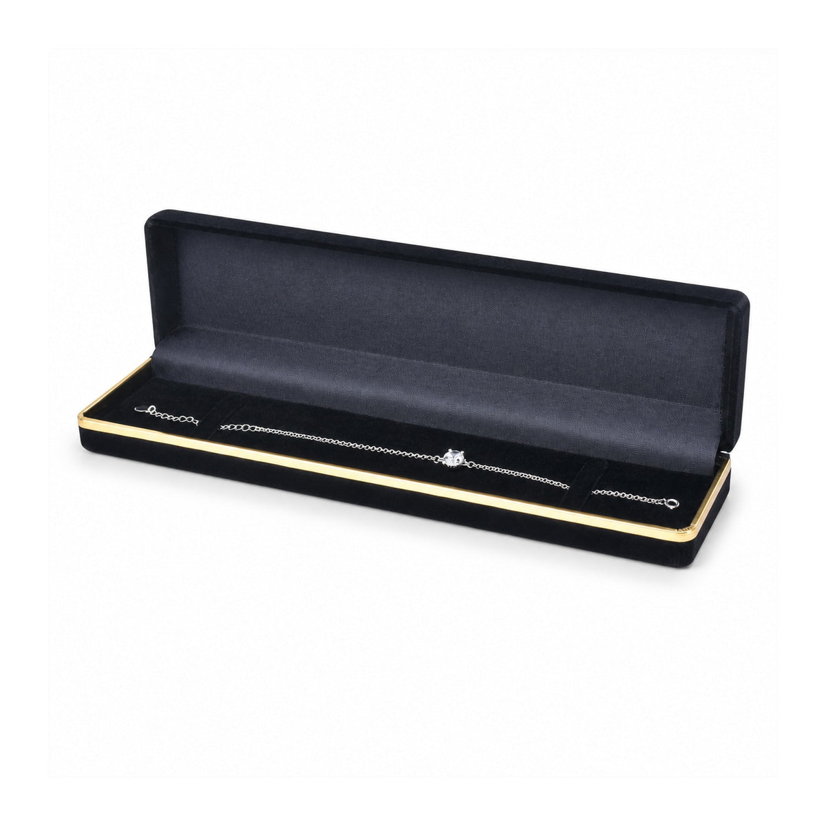 Black flocked bracelet box with gold trim open with silver bracelet.