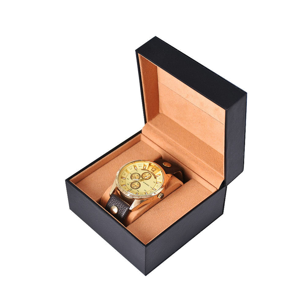 Open black single watch presentation box with tan lining and a wristwatch resting on the padded holder.