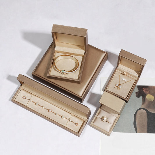 Champagne jewelry box group with open ring, pendant, bangle and bracelet boxes, preserving the original stacked arrangement.