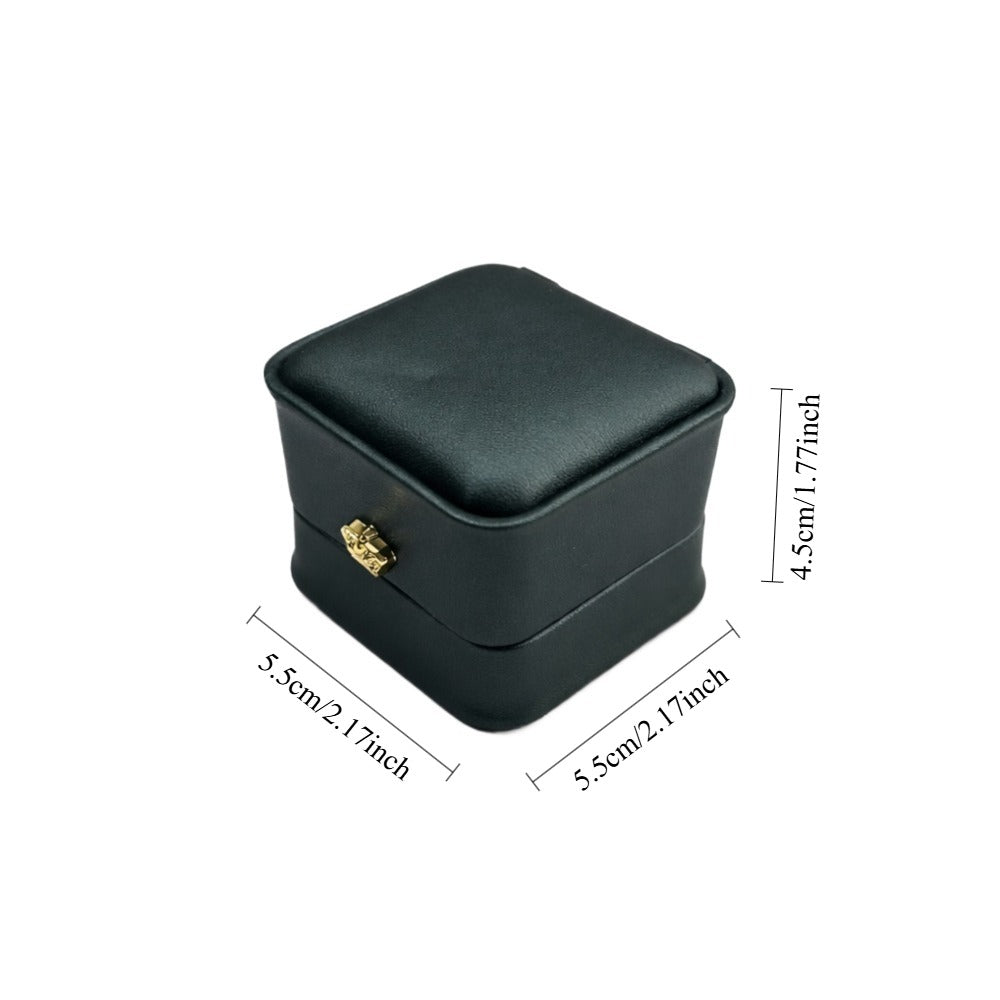 Deep green single-ring presentation box with curved corners, hinged lid, and padded jewelry holder.