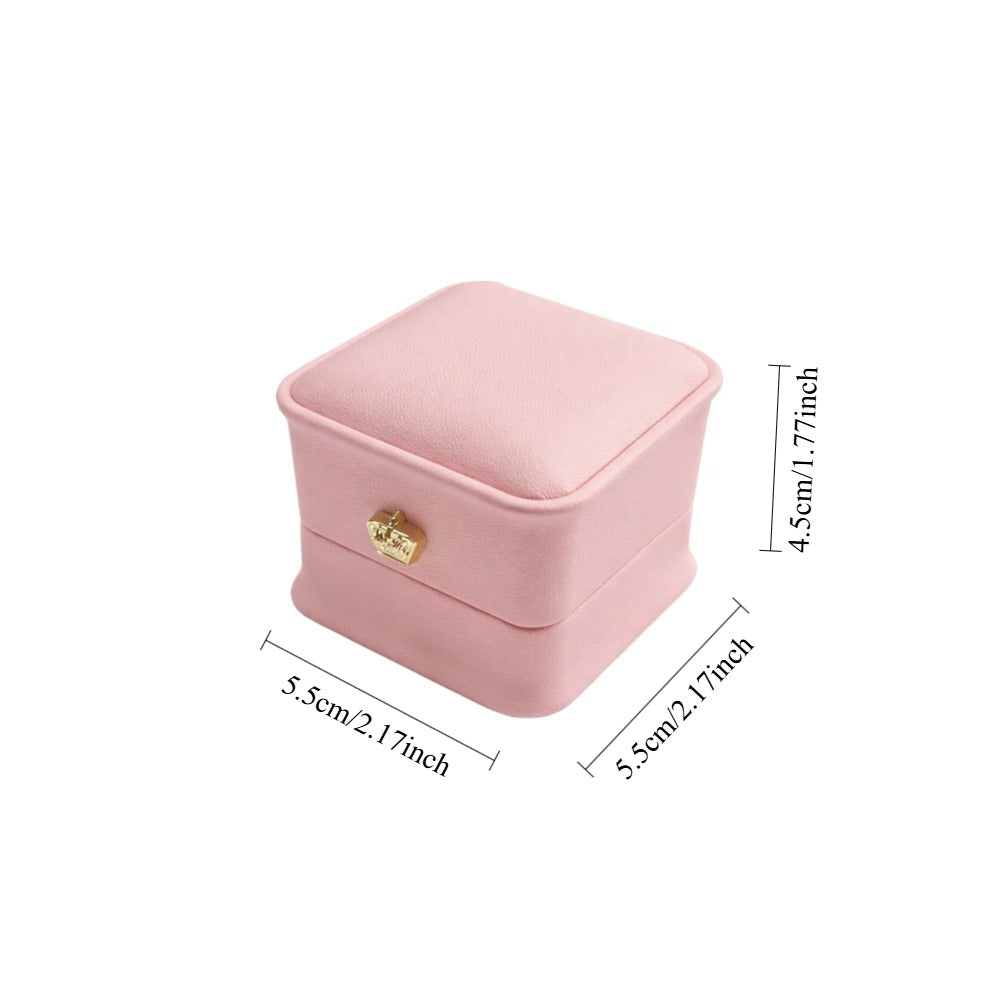 Jeweller Buy light pink ring case with curved corners, hinged lid, and padded white interior.
