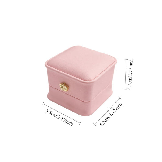 Jeweller Buy light pink ring case with curved corners, hinged lid, and padded white interior.