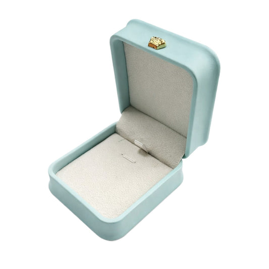 Open Tiffany Blue rounded pendant box with a pale padded interior, jewelry securing loops, and gold-tone ornament.