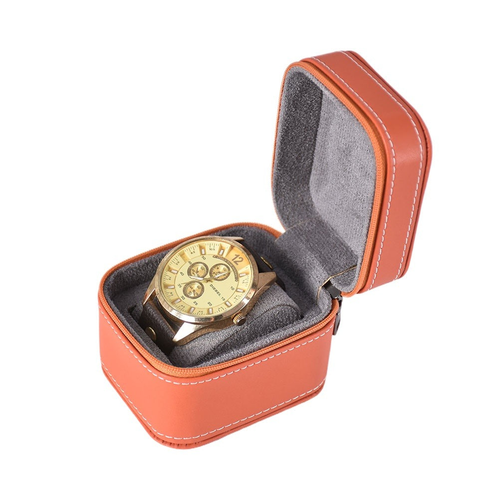 Open orange zipper watch case with a gray padded cushion for one wristwatch.