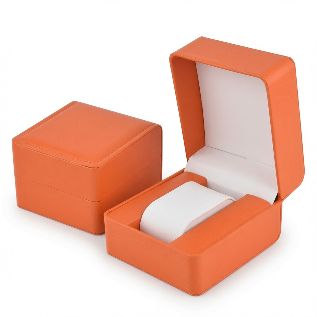 Jeweller Buy single timepiece display box shown open with an orange exterior and padded