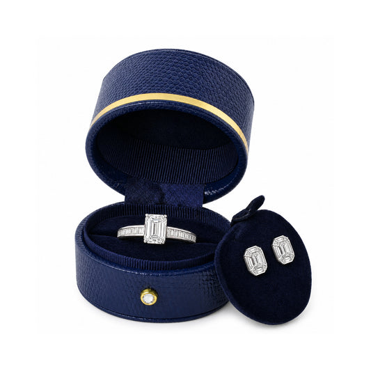 Blue oval ring box L022R with gold trim, open in three-quarter view with a ring and earrings.