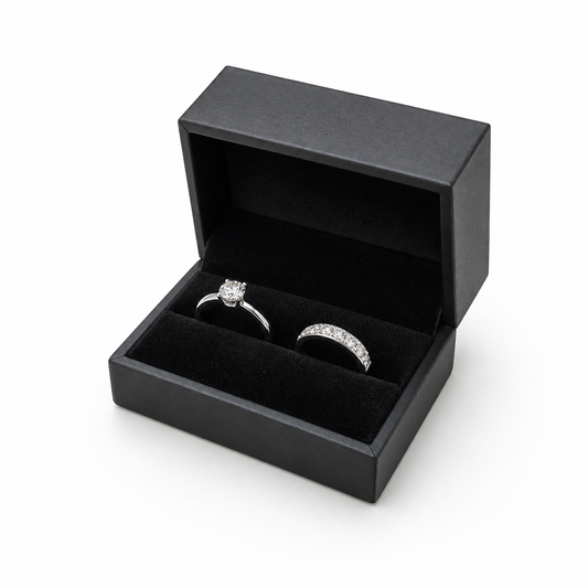 Open black PU double ring box displaying two wedding rings