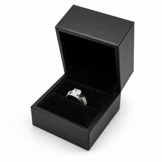 Open black PU ring box displaying a solitaire engagement ring
