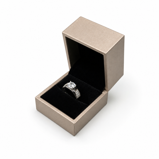 Open champagne PU ring box displaying a solitaire engagement ring