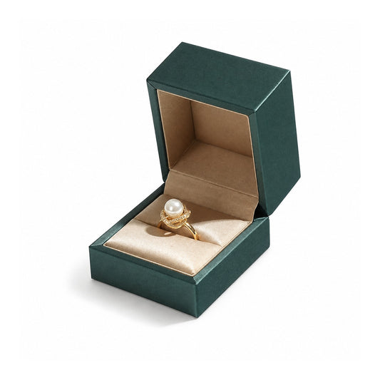 Green ring box with gold trim and beige lining, displaying a pearl ring.