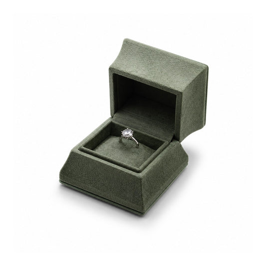 Sage green ring box with matching textured lining and a diamond ring.