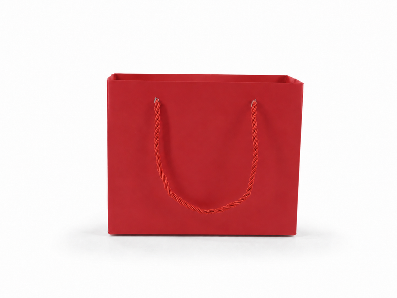 Front view of red jewelry store gift tote bag with rope handles, 7.75 × 3.5 × 6.25 in
