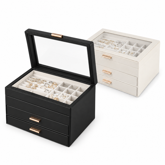 White and black three-layer jewelry boxes with drawers, showing one clear lid open toward the lower left