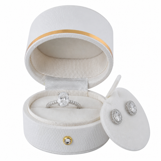 White oval luxury ring box with oval diamond wedding ring and matching halo earrings