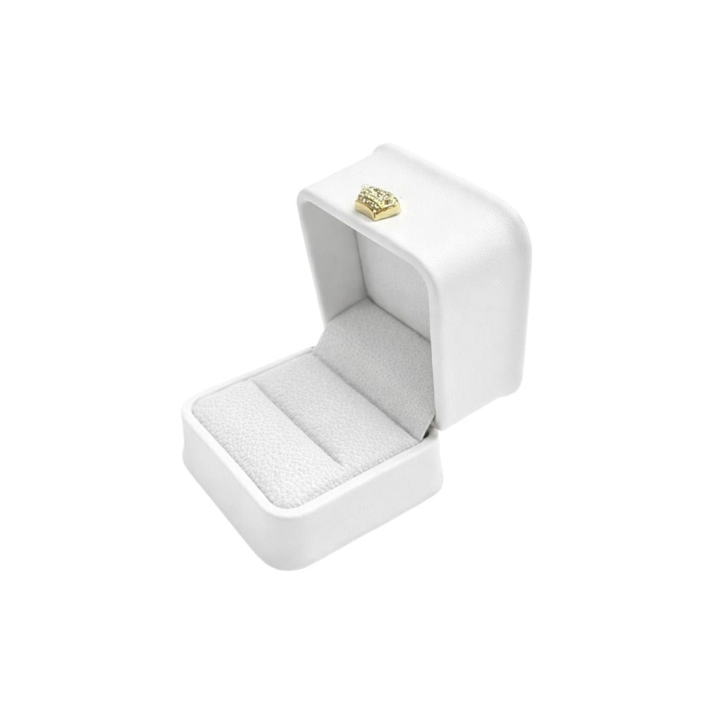 Open white rounded-corner ring gift box with a matching padded insert and gold-tone ornament.